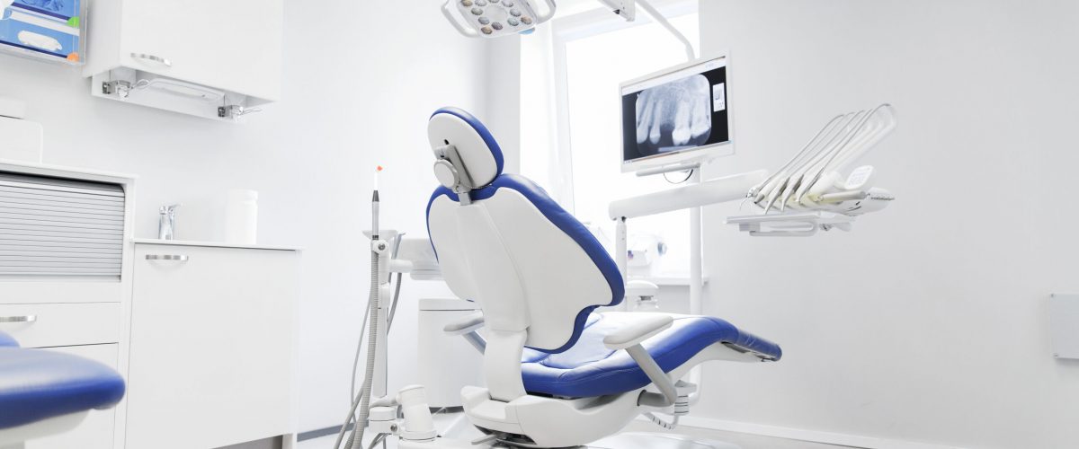 dentistry, medicine, medical equipment and stomatology concept - interior of new modern dental clinic office with chair