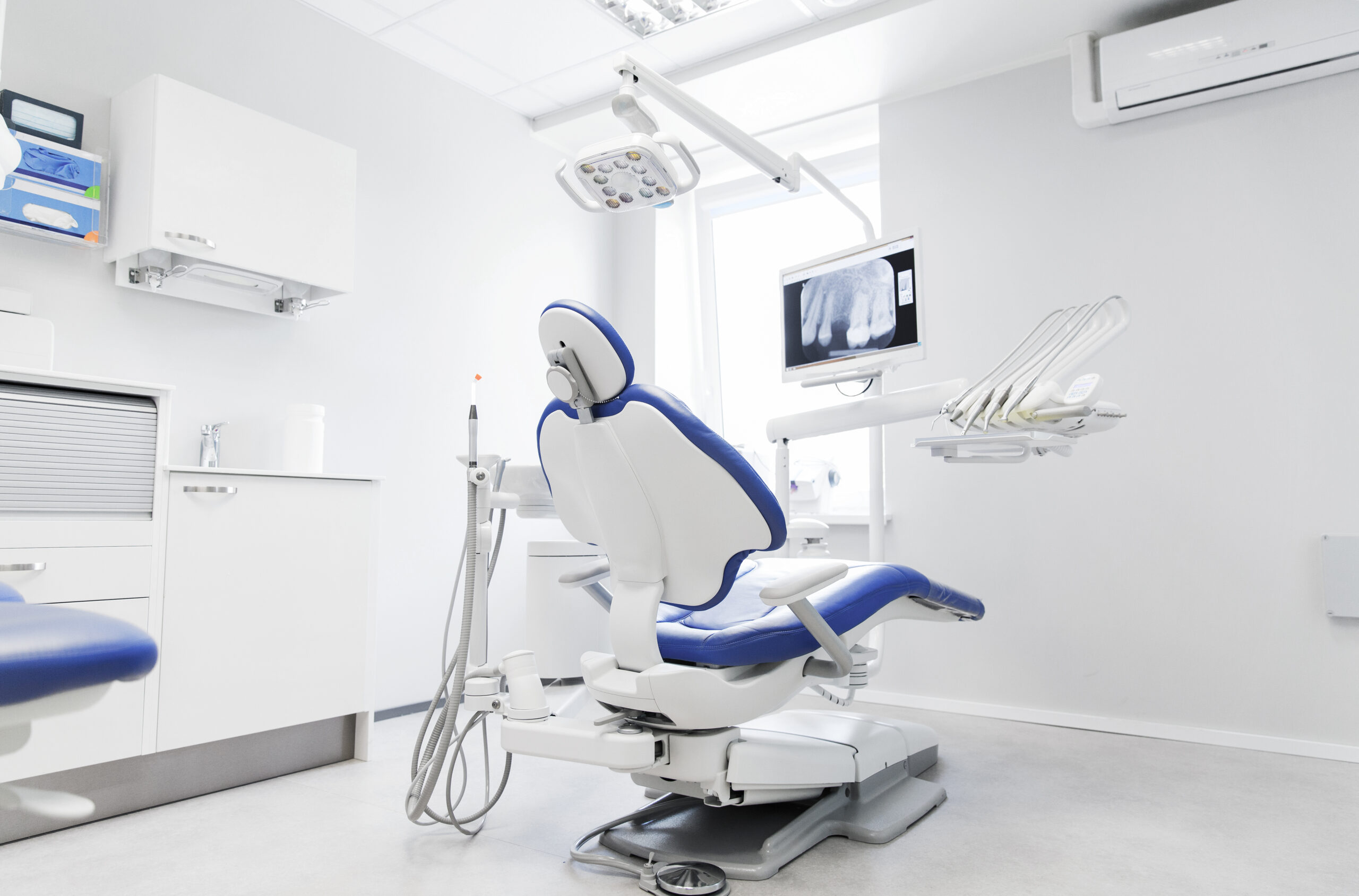 interior of new modern dental clinic office dentistry, medicine, medical equipment and stomatology concept - interior of new modern dental clinic office with chair